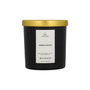 Black candle with gold lid and white label on a white background