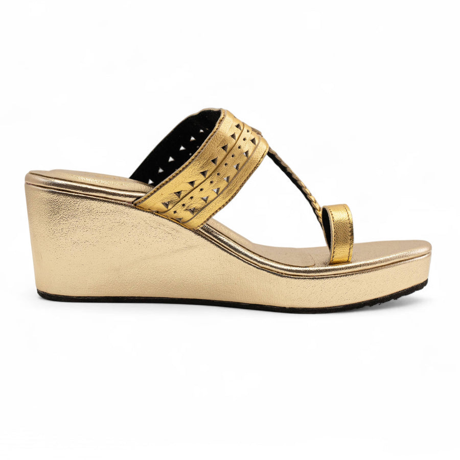 A single metallic gold wedge sandal with a toe loop strap and a perforated decorative band, shown in profile against a white background.